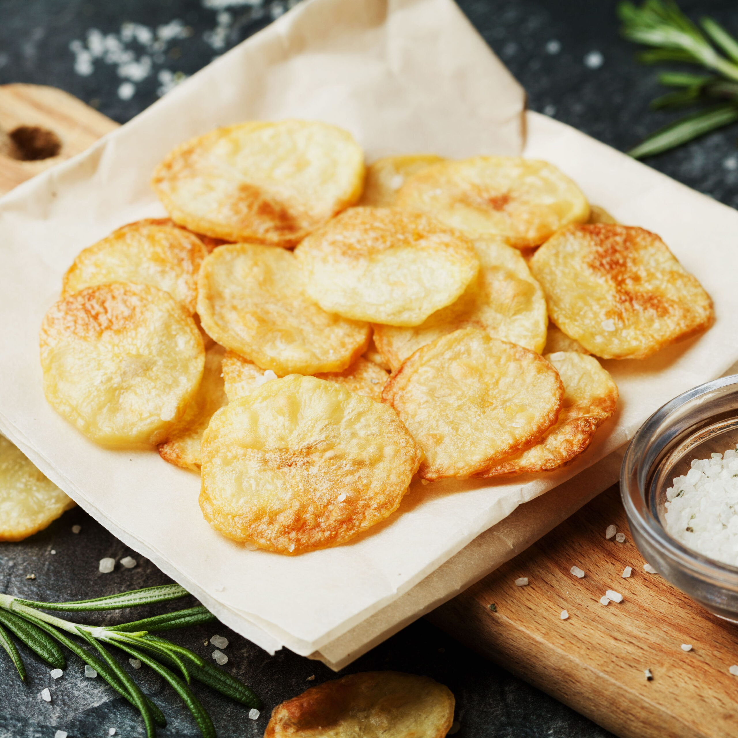 baked potato chips on tray beside dish of salt