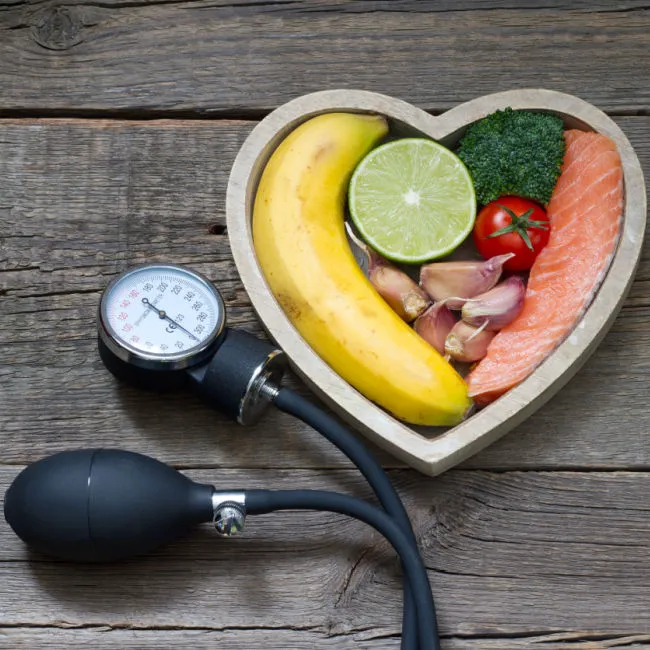 sphygmomanometer beside heart health foods in shape of heart