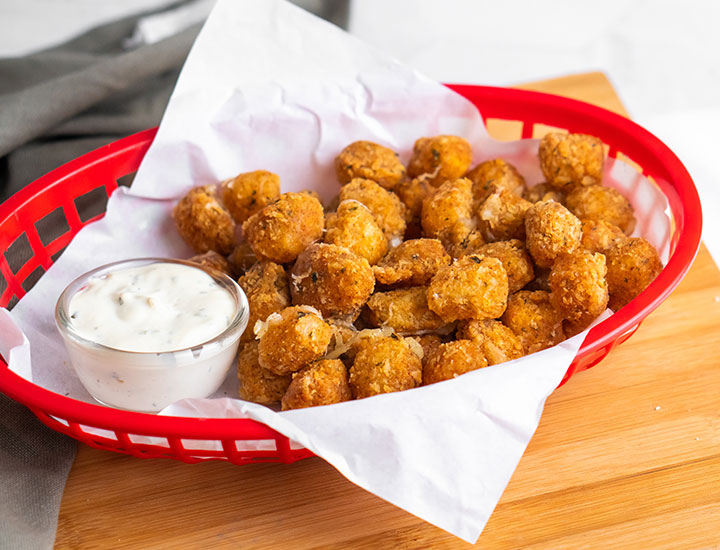 Basket of fried cheese curds with sauce