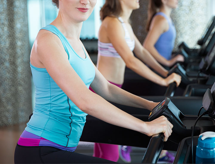 Group of women using treadmills