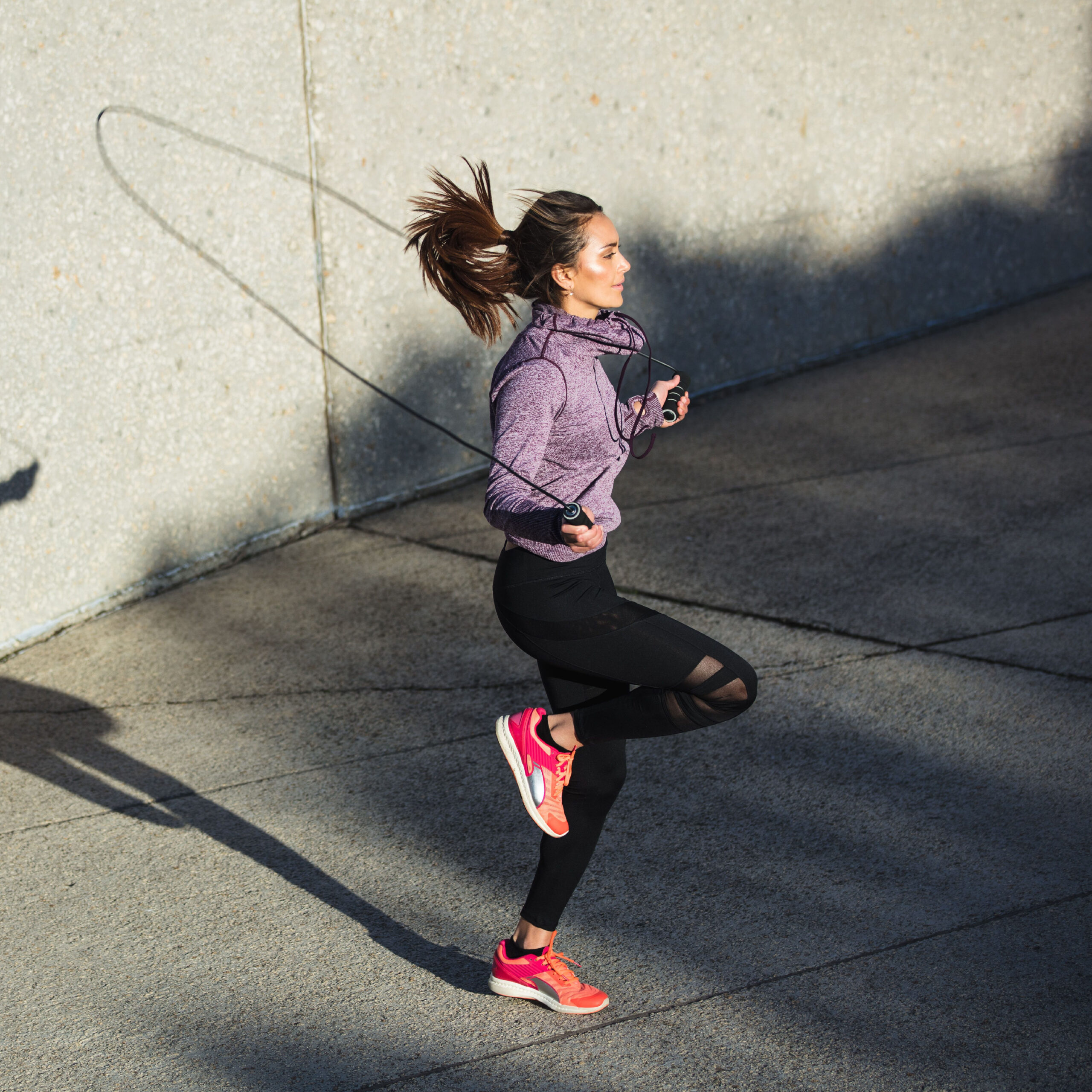 woman jumping rope outside
