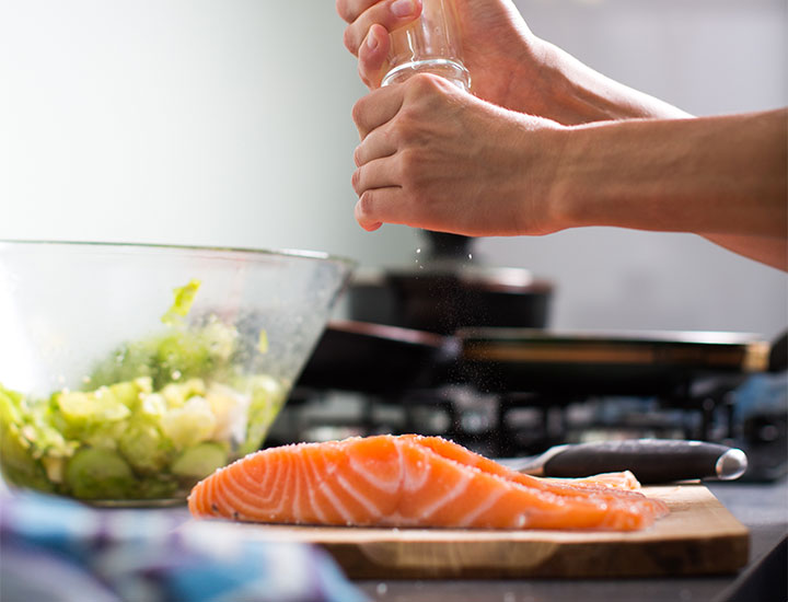 Person preparing salmon