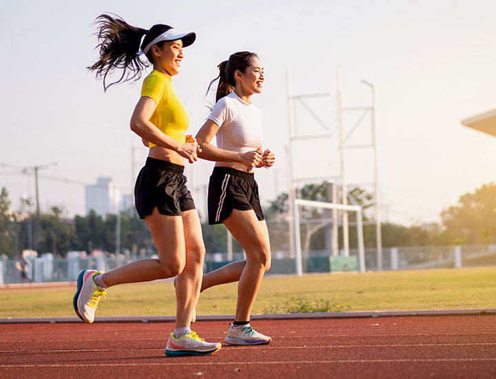 Two women jogging on a track