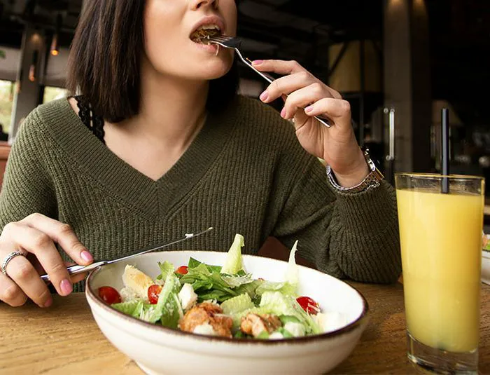Woman eating a salad.