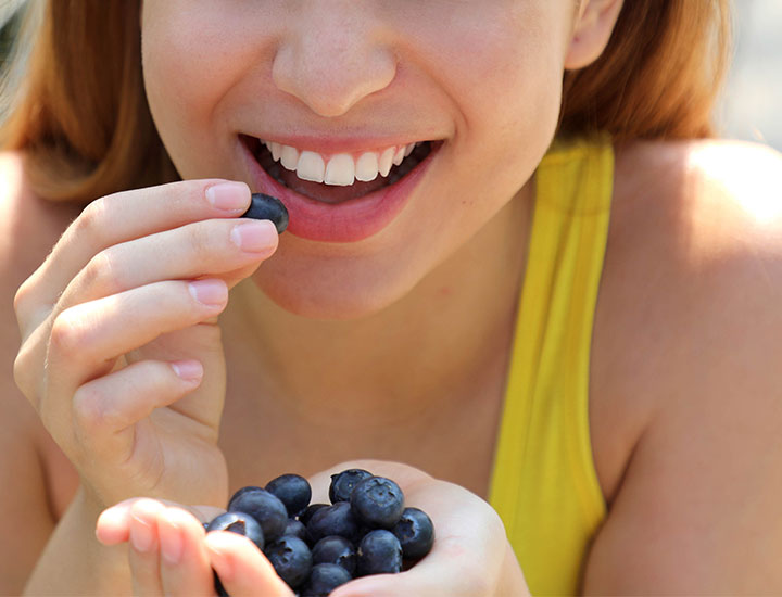 Woman eating blueberries