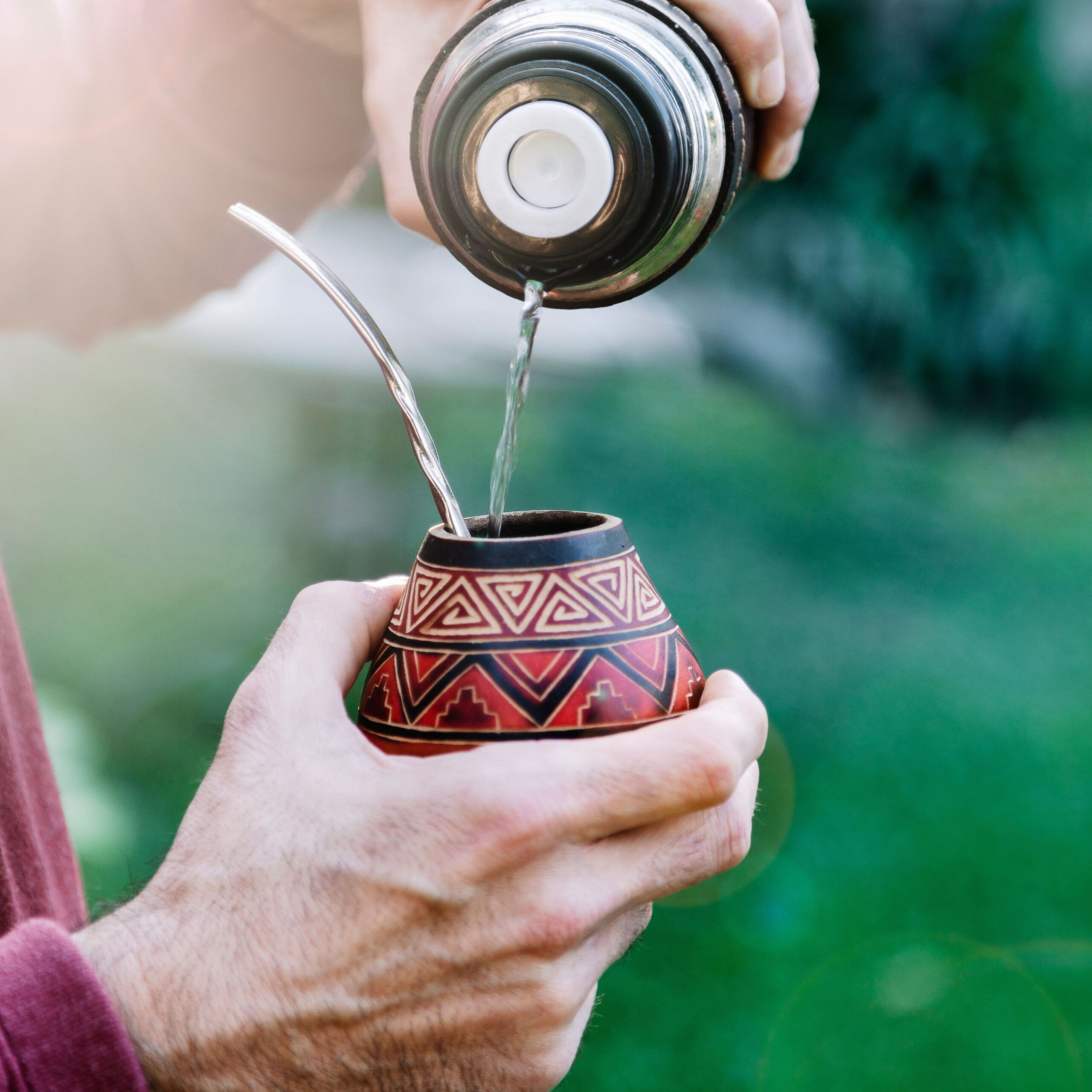person pouring yerba mate