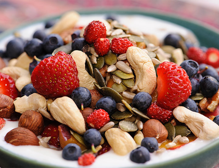 Yogurt topped with berries and nuts
