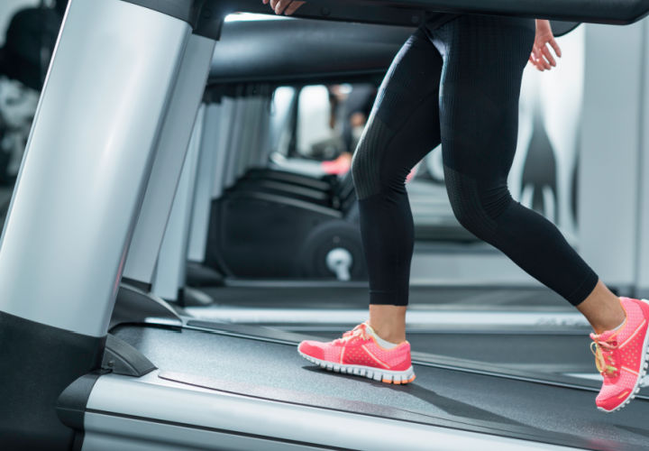 Woman walking on an incline on a treadmill