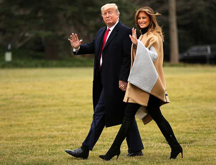 Donald and Melania Trump walk across White House lawn