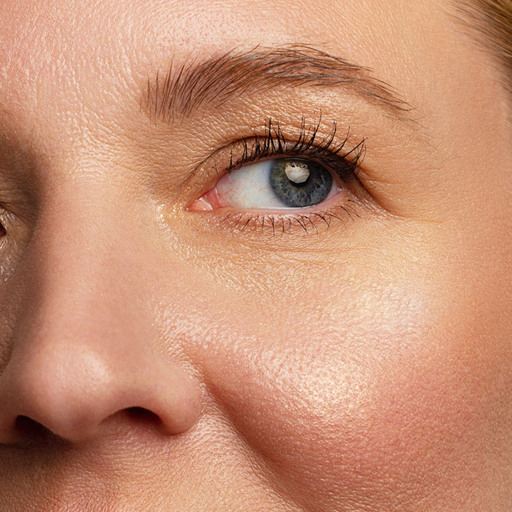 closeup shot of older woman with radiant glowing skin and under-eyes