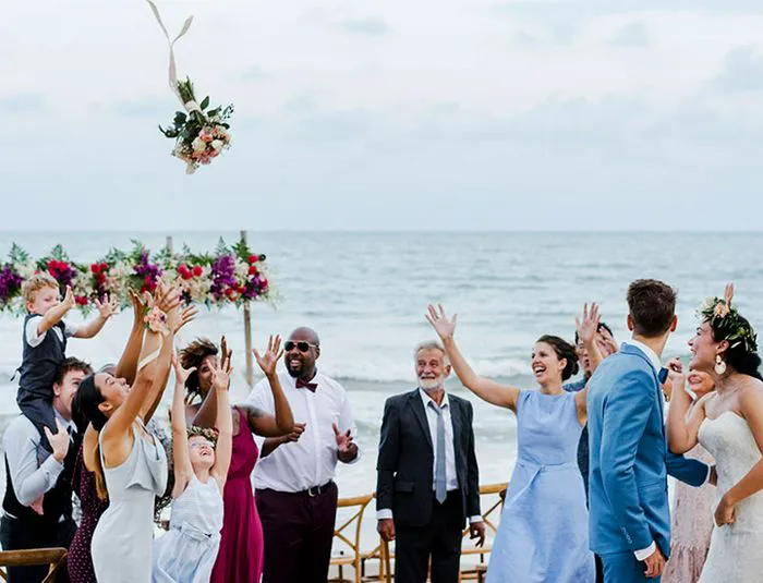 Garter/Bouquet Toss Bride tossing bouquet on the beach