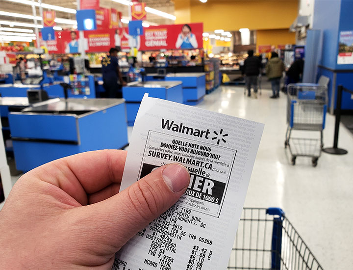 walmart receipt man holding paper store