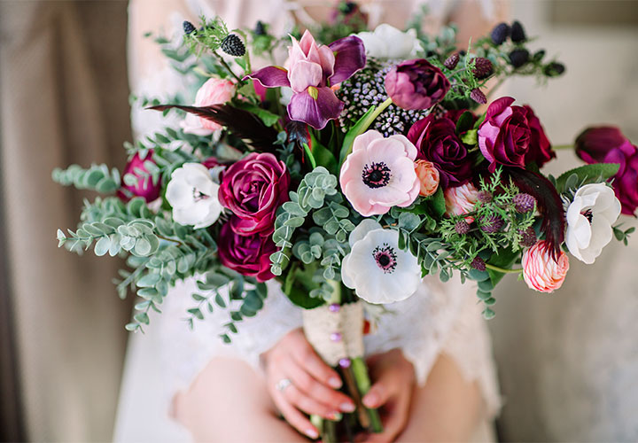 Bride holding jewel-tone bouquet