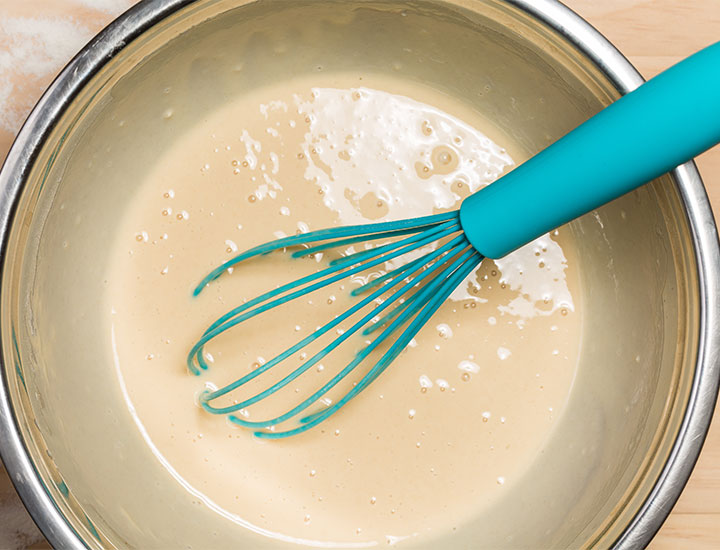Mixing pancake batter in a bowl