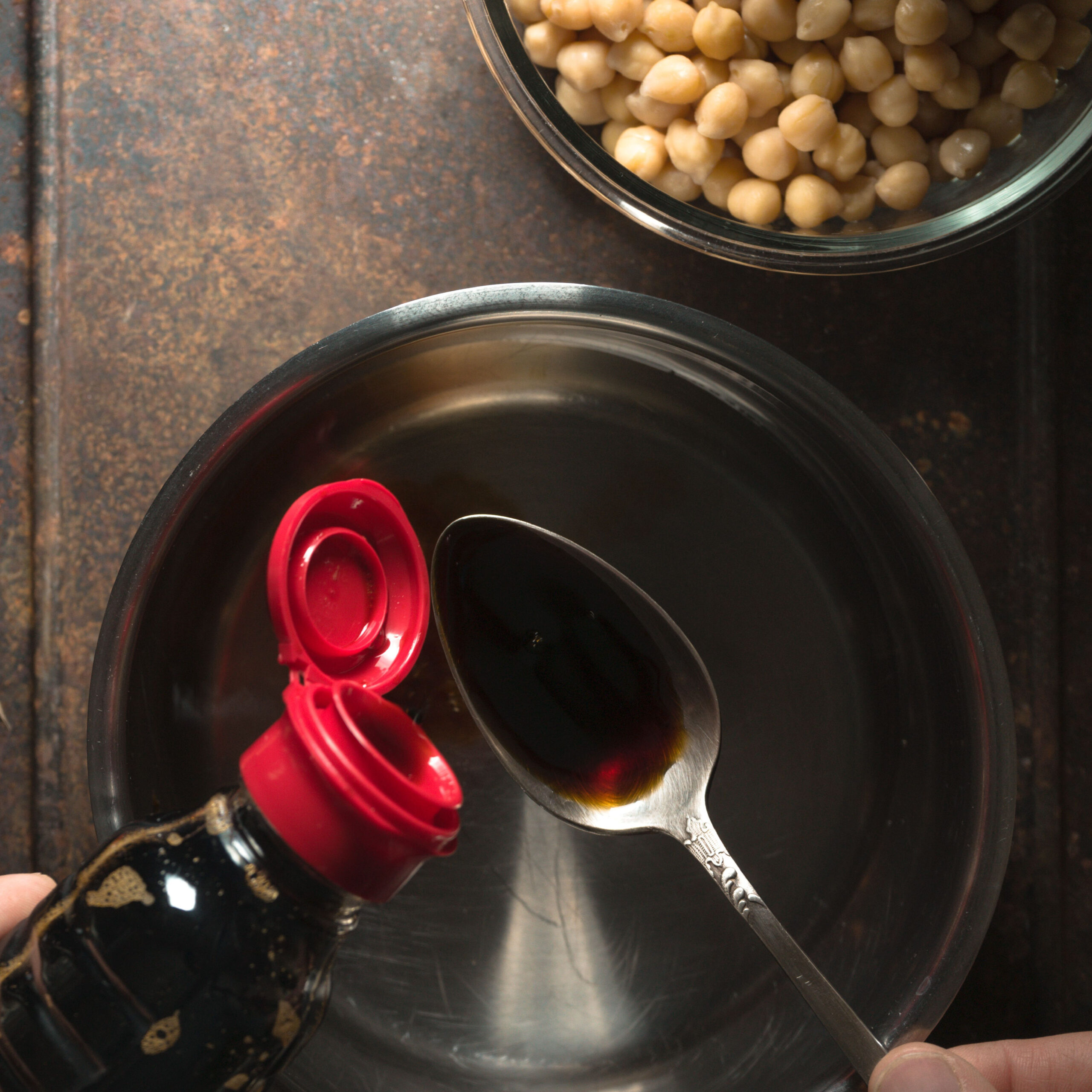 soy sauce being poured into spoon