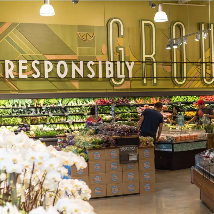 whole foods produce section well-lit store fresh fruits vegetables