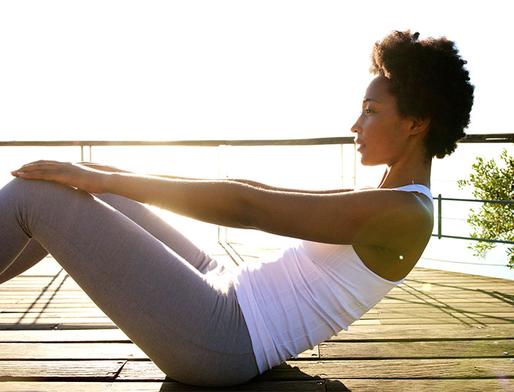 Woman doing sit-up outside