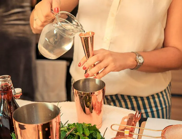 Woman making cocktails at home