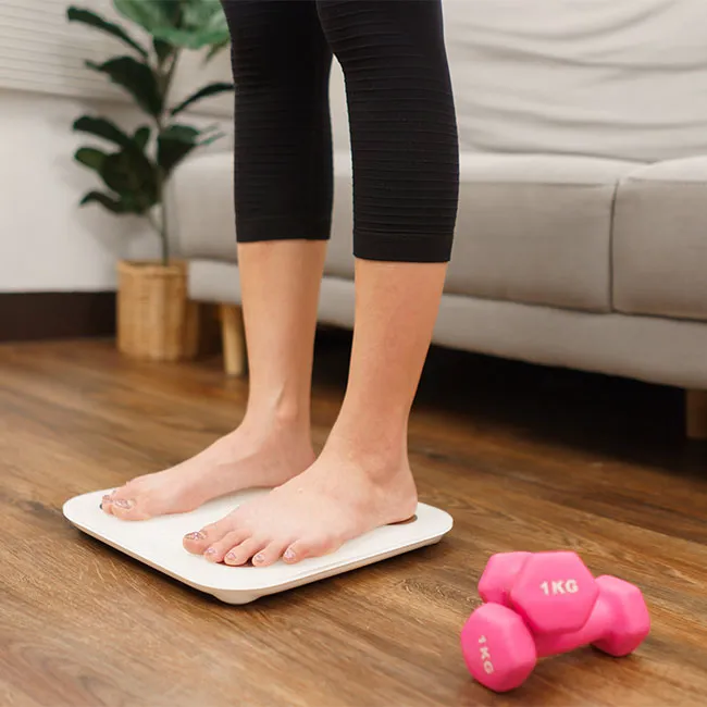woman standing on scale at home