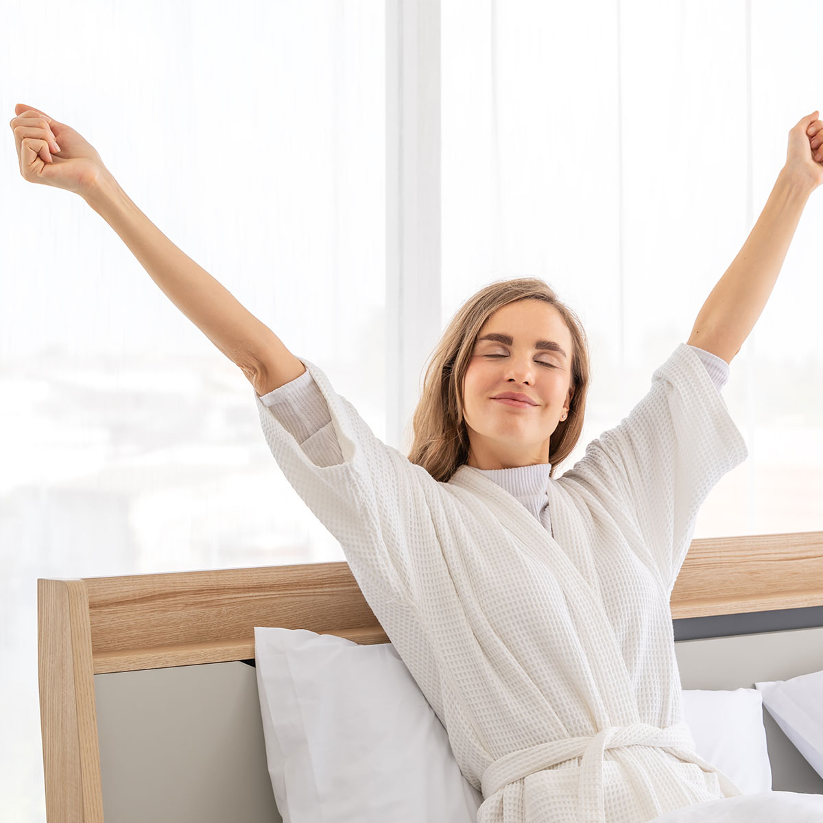woman waking up feeling well-rested and energized