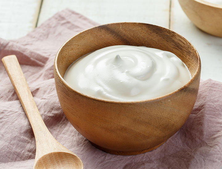 Wooden bowl of yogurt