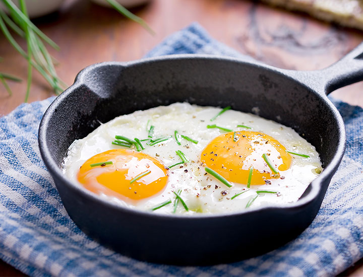 Cast iron skillet with two fried eggs