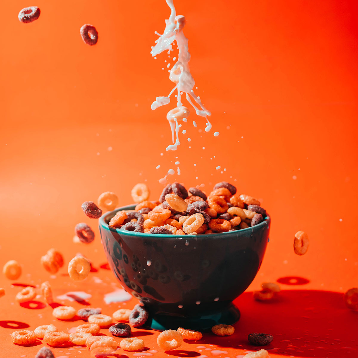 cereal splashing with milk in bowl