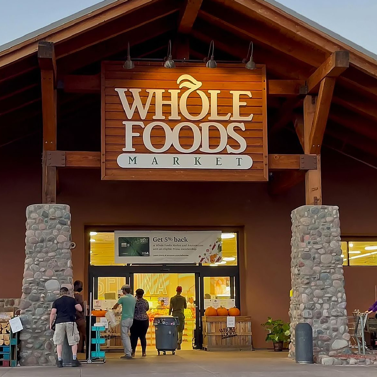 whole foods market outdoor sign stone pillars brown building