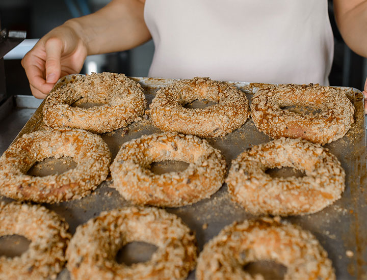 Woman baking a tray of bagels