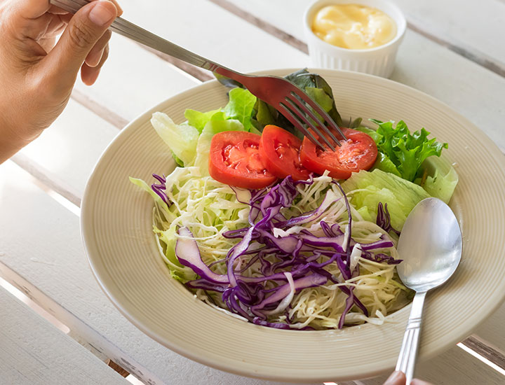 Woman eating a fresh salad