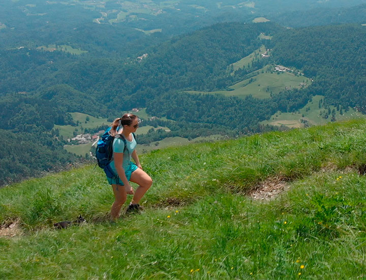 Woman hiking up a steep hill