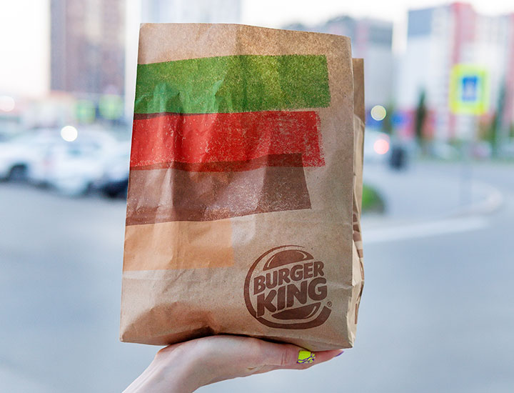 Woman holding a takeout bag from Burger King