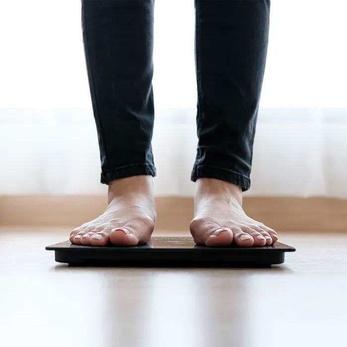 woman standing on scale