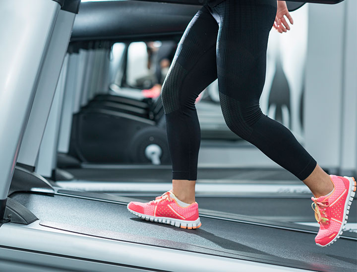 Woman walking on an inclined treadmill