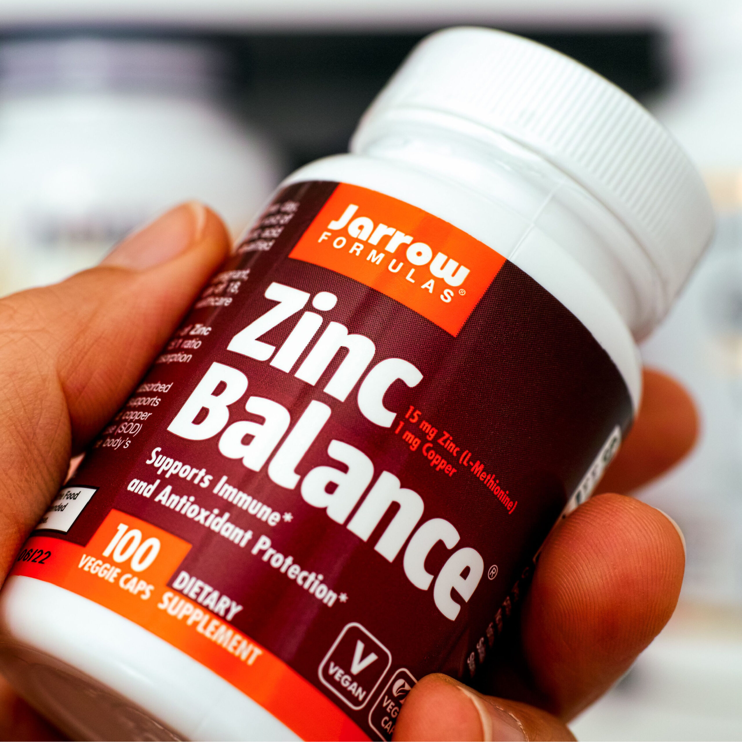 hand holding bottle of zinc supplements