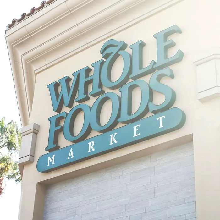 whole foods signage green lettering close-up sunshine