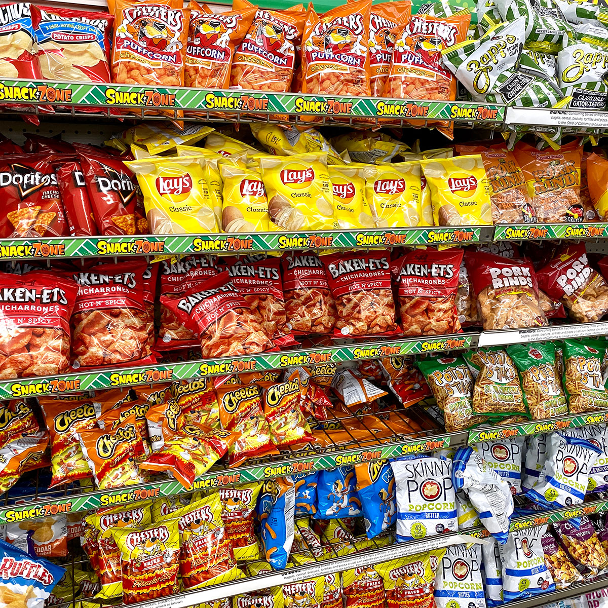 potato chips at the store shelves pork rinds bags lined up