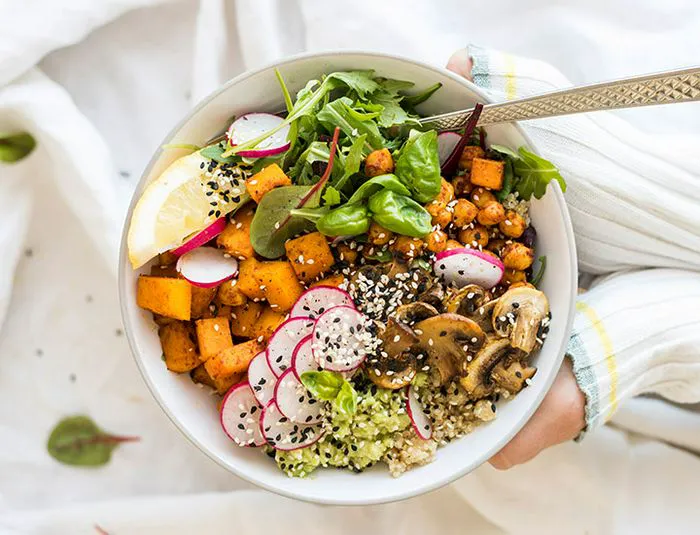 healthy quinoa bowl with vegetables avocado and seeds
