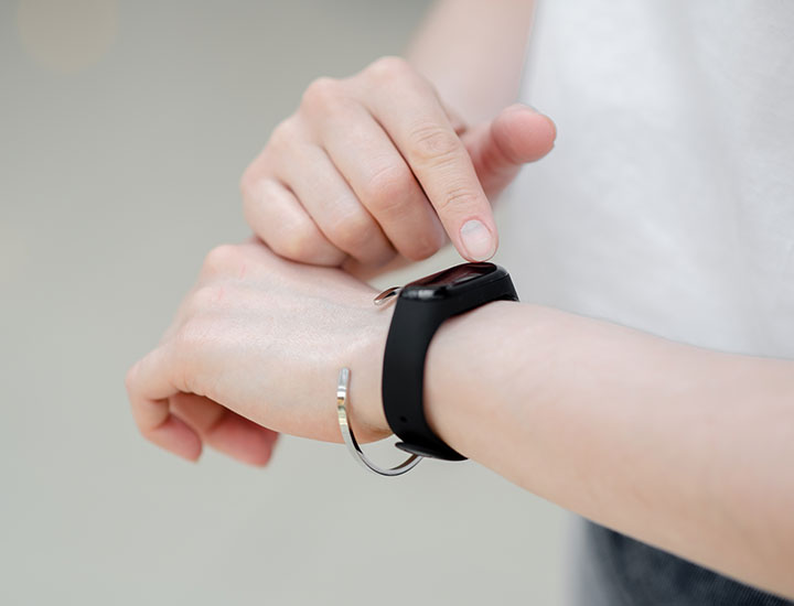 woman checking her pedometer for step count