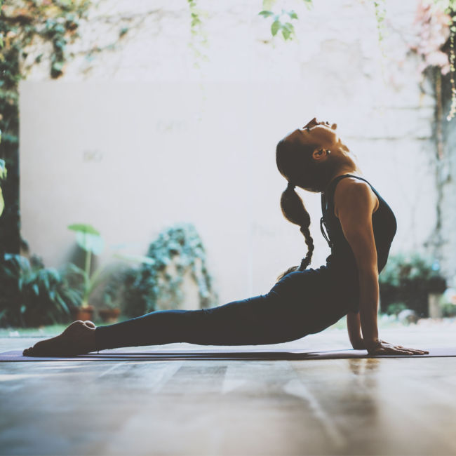 woman doing yoga stretch inside