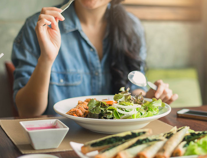 woman eating a salad plate