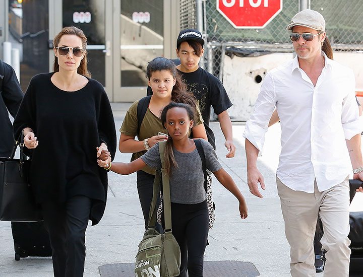 Brad Pitt and Angelina Jolie arrive at LAX with some of their children in 2014