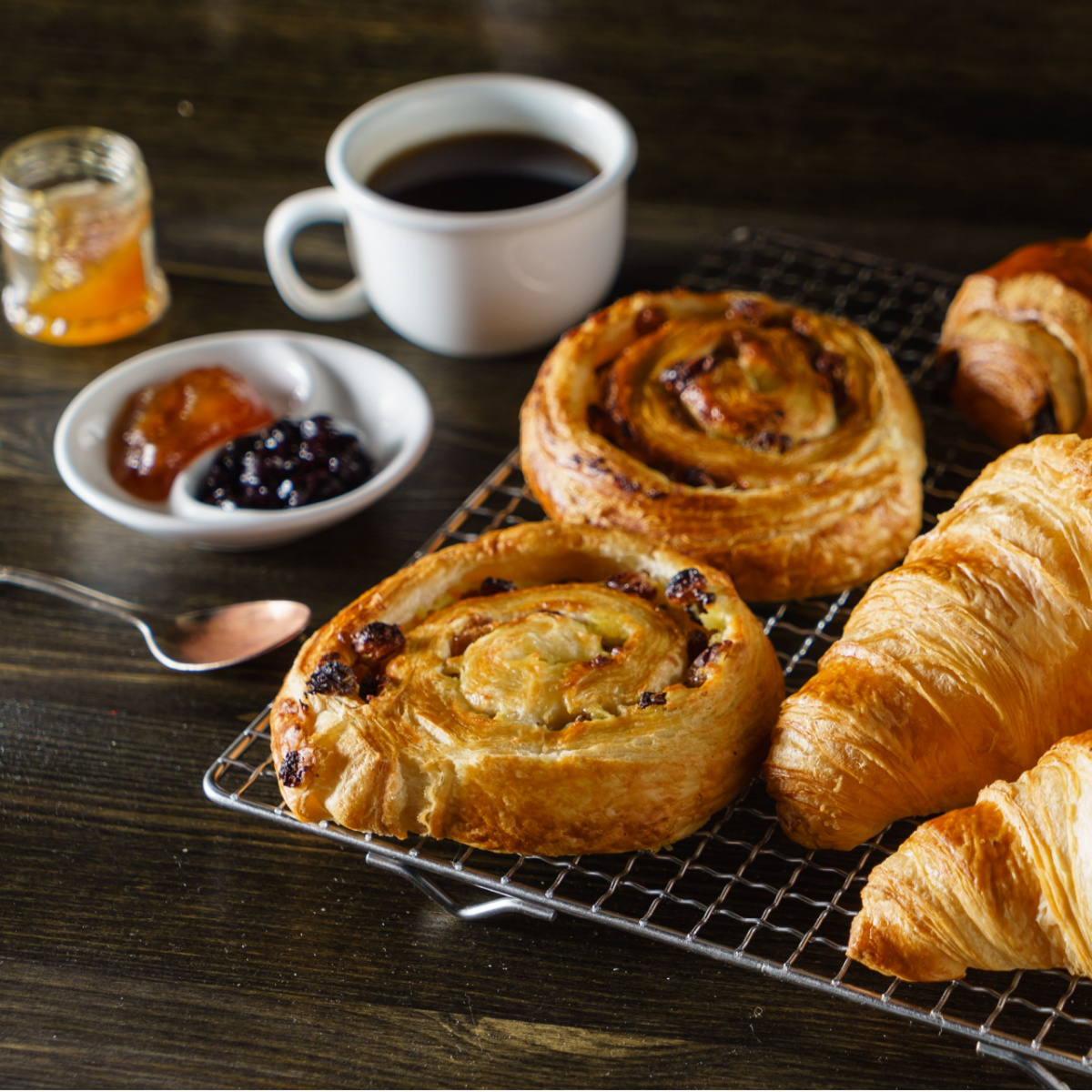 various pastries with coffee and jam