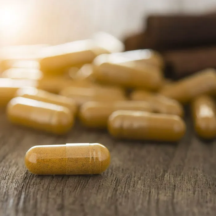 Assorted herbal supplements in various containers for wellness.