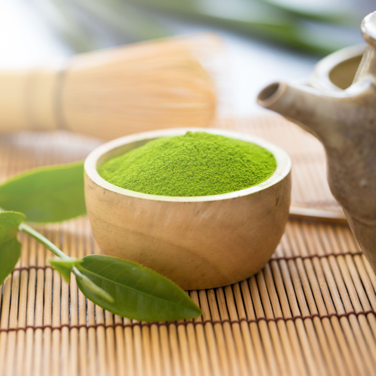 small wooden bowl of matcha powder