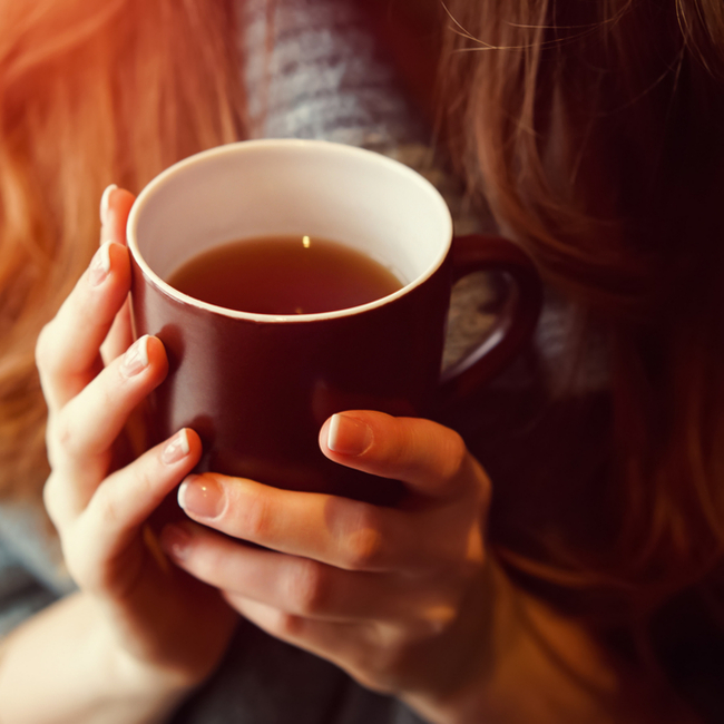 woman holding mug of tea