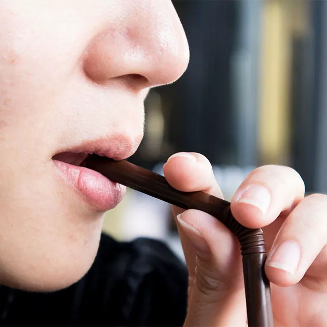 woman sipping on straw