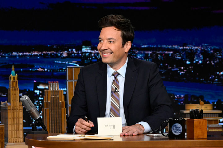Jimmy Fallon sitting at his desk while hosting 'The Tonight Show'