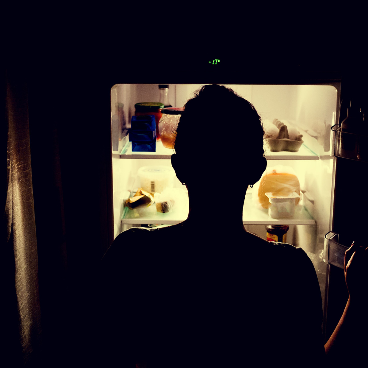 woman looking inside fridge
