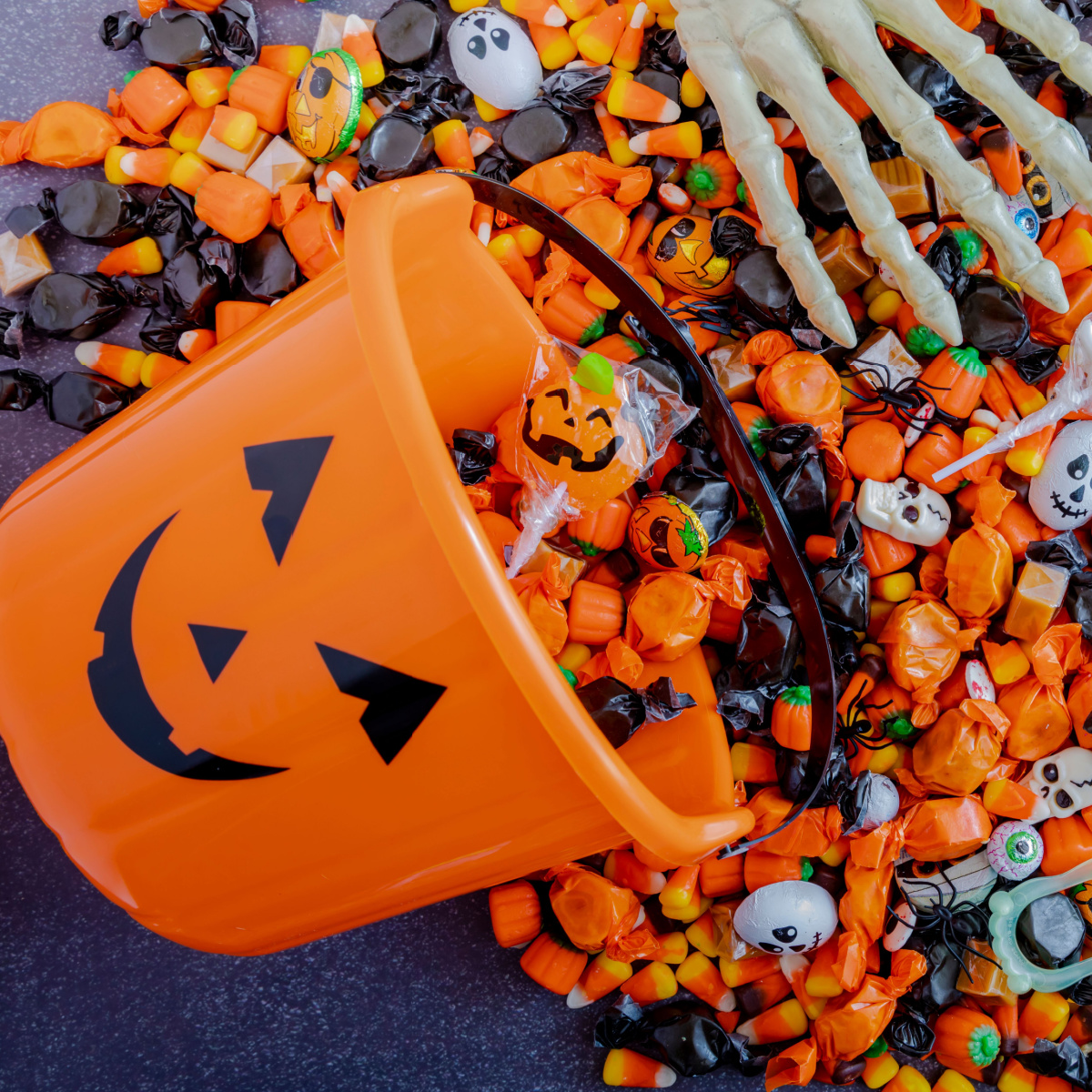 halloween candy spilling out of halloween bucket